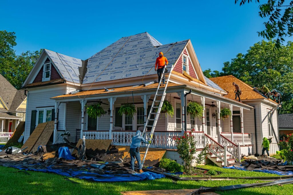 Roofers replace the roof of a historic home in Weatherford, Texas.