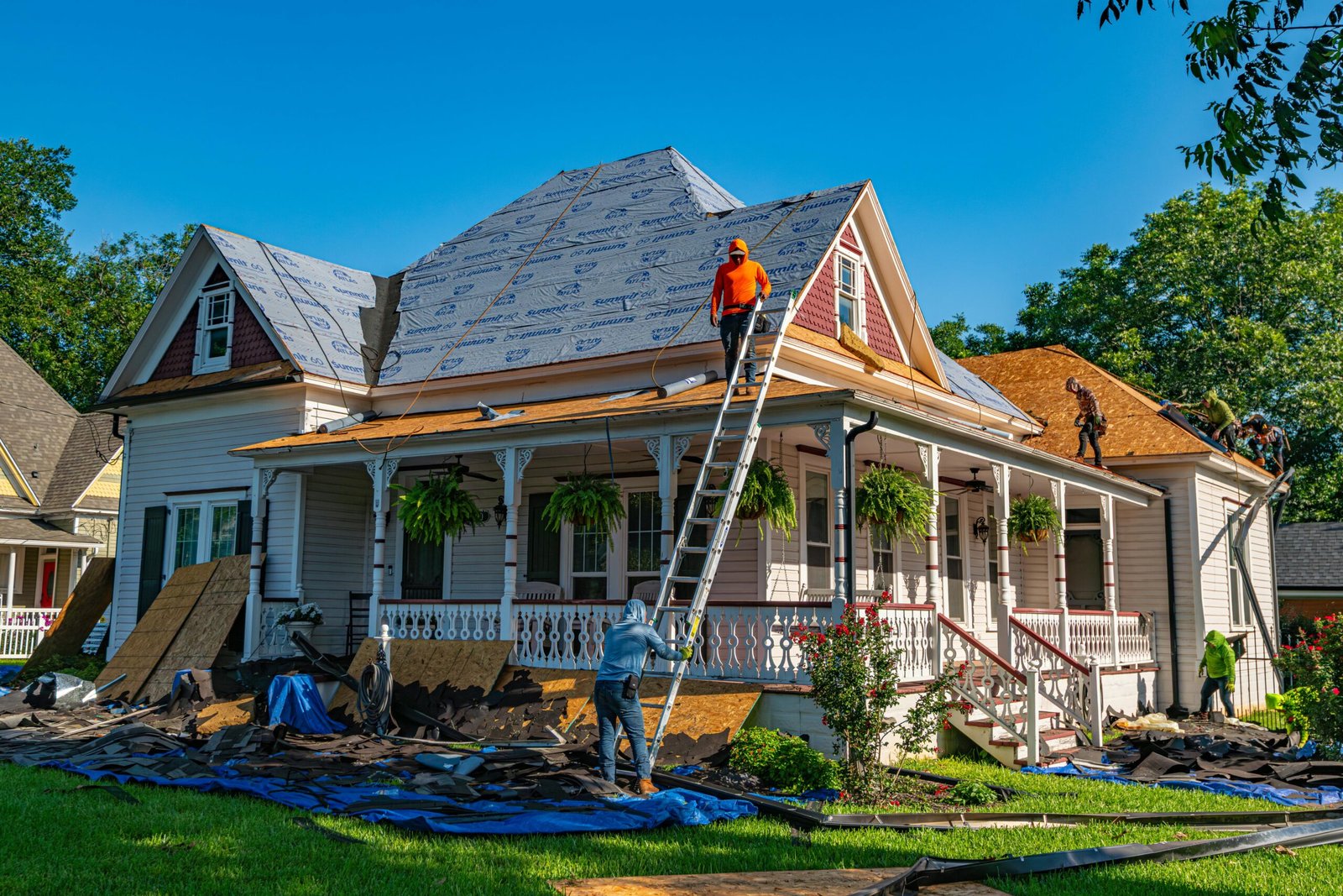 Roofers replace the roof of a historic home in Weatherford, Texas.
